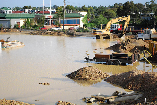 Flooded construction site with water damaged equipment